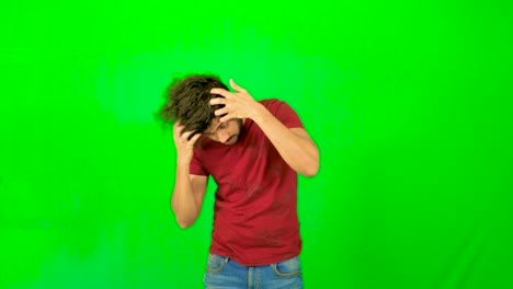 indian-male-model-touching-his-hair-with-green-screen---green-background