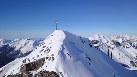 Drone-Rise-Over-Mountain-Peak-To-Chirlift