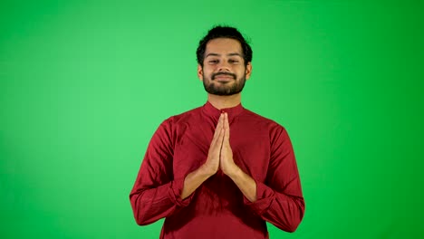 Indian-guy-say-hello-with-green-background---indian-green-background