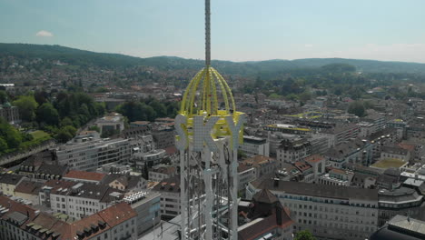 Close-aerial-drone-shot-orbiting-around-amusement-park-free-fall-tower-in-Zürich,-Switzerland-during-Zürichfest