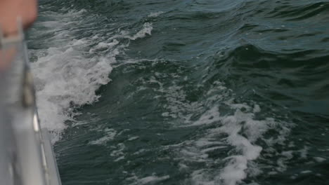 Close-Up-of-Waves-off-the-side-of-Boat