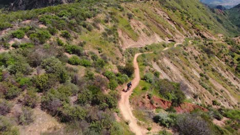 Drone-shot-of-mountain-biker-riding-a-trail-in-Orange-County