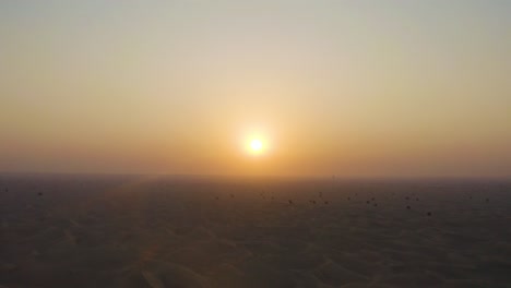 Aerial-Shot:-Flying-over-the-desert-sand-dunes-towards-the-sunset