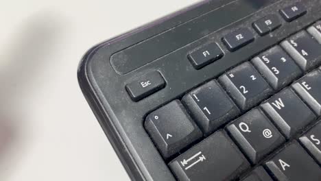 Pressing-the-escape-button-on-an-old-dirty-computer-keyboard
