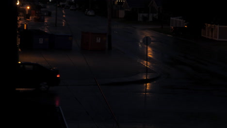 Car-turning-at-Corner-of-Wet-Street-in-Rain-at-Night
