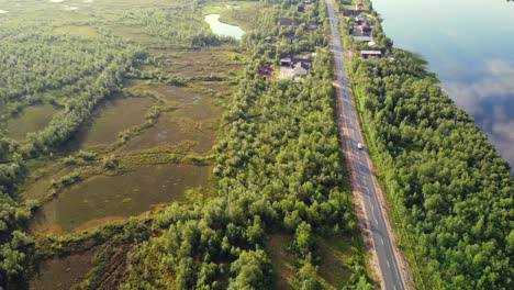 Solo-traveling-on-long-Empty-highway-along-Tornio-river,-Finnish-Swedish-border