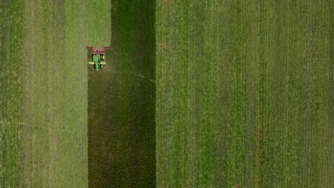 Drone-shot-of-Tractor-Mowing-the-tall-grass-from-up-above