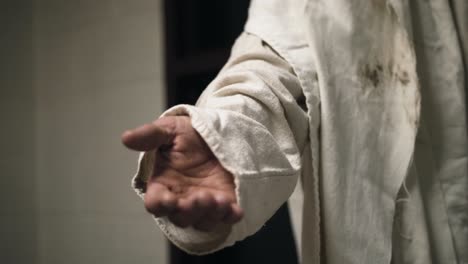 Jesus-wearing-a-white-robe-extends-his-hand-in-slow-motion