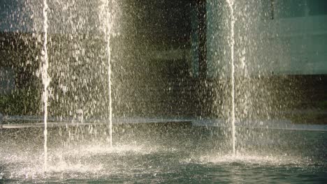Water-drops-texture-of-fountains-spreading-droplets-over-pond-surface