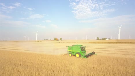 A-Midwest-farmer-harvesting-a-soybean-field-with-a-combine,-tractor,-and-auger-wagon