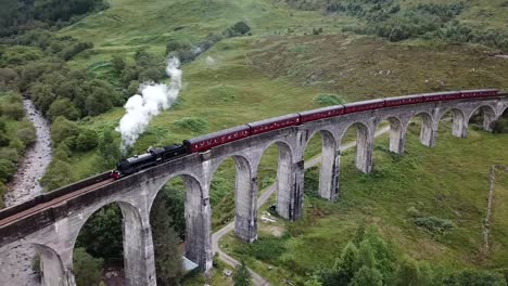 Aerial-shot-of-the-Jacobite-steam-train-crossing-the-Glenfinnan-Viaduct-in-Scotland