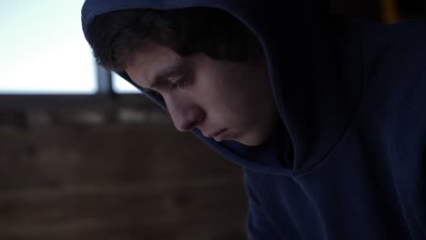 Medium-closeup-of-a-teenage-boy-looking-sad-and-depressed