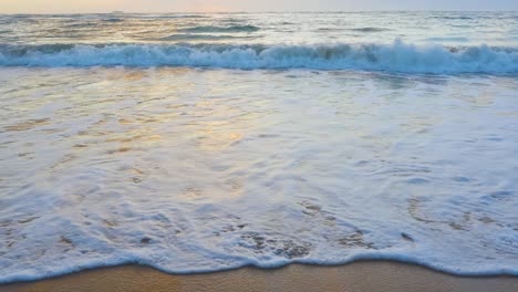 Shot-following-the-waves-up-the-beach-at-high-tide-and-sunset-on-Oahu-Hawaii