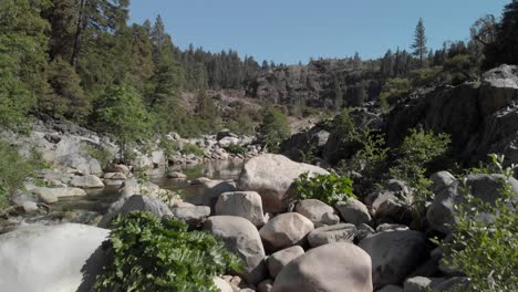 Aerial-flight-up-small-rapid-on-narrow-section-of-sunny-Yuba-River