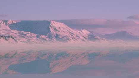 Pink-Snowy-Mountains-Reflected,-Water,-Dawn-Mist,-Reykjavik,-Timelapse