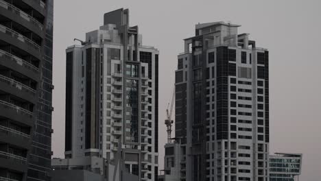 Two-Dubai-apartment-buildings-with-unique-architectural-designs-in-Dubai,-United-Arab-Emirates
