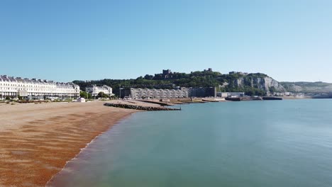 Slow-pan-right-to-left-showing-castle-cliffs-and-beach-of-Dover-on-a-sunny-summer-morning