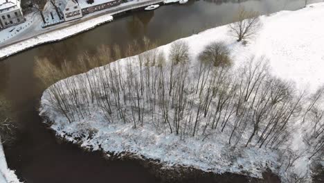 Droneshot-of-snowy-Dutch-landscape-with-a-little-church-and-castle-Slot-Zuylen