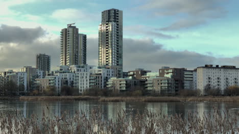 Urban-Nature,-Skyscrapers-and-Tower-blocks-with-Lake-and-Wildlife-in-foreground,-Urbanisation