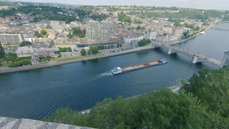 View-at-bridge-of-Huy-with-barge-on-The-Maas,-Pont-Roi-Baudouin,-Belgium,-Ardennes,-Europe,-4K,-50fps