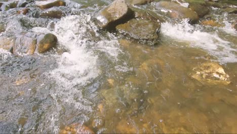 Slowmotion-view-of-water-and-stones,-Ardennes,-Belgium,-Europe,-filmed-in-2