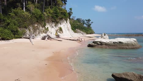 A-group-of-tourists-explore-a-remote-beach-in-the-distance-on-a-remote-andaman-island-in-India