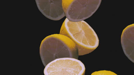 Fresh-Juicy-Lemons-Falling-in-Super-Slow-Motion-on-Black-Background
