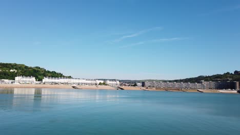 Still-channel-water-at-Dover-beach-on-a-clear-sunny-summer-day-with-white-historic-architecture-visible