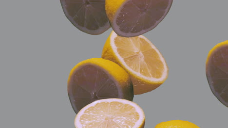 Limones-Cayendo-En-Cámara-Lenta-Sobre-Fondo-Gris,-Iluminando-El-Color-Amarillo-Y-Gris-Definitivo-Del-Año-2021