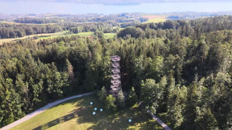 Aerial-drone-shot-flying-down-and-tilting-up-showing-the-Pfannenstiel-observation-tower