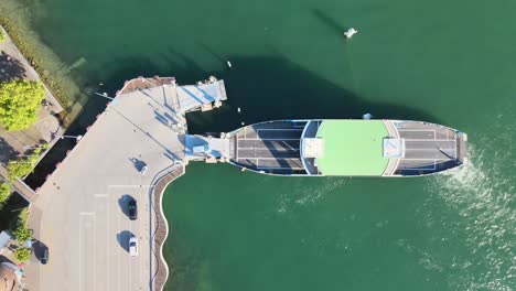 Top-down-aerial-drone-shot-of-car-ferry-loading-cars-at-Meilen-on-Lake-Zürich-in-Switzerland