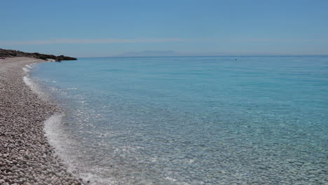 Clean-sea-water-on-peaceful-shore-of-Mediterranean-washing-pebbles-beach