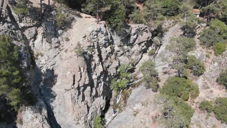 establishing-drone-shot,-adventure-climber-climbing-outdoors-mountains