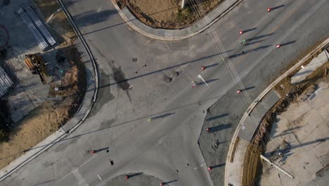 Drone-aerial-rotation-of-bicycle-riders-in-construction-intersection