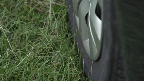 Close-Up-Of-A-Car-Wheel-Parked-On-Green-Grass