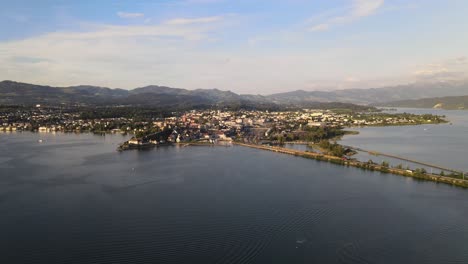 Aerial-drone-shot-flying-sideways-over-lake-Zurich-looking-over-Rapperswil-at-sunset-in-summer