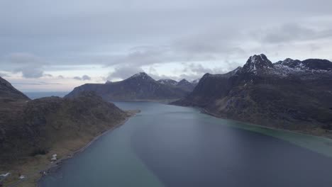 Aerial-view-above-a-shallow-fjord-in-cloudy-Lofoten,-Norway---pan,-drone-shot