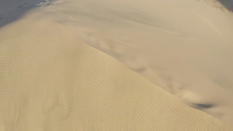 Vertical-drone-aerial-perspective-of-the-crest-of-big-dune-in-Kelso-dunes-National-Park,-California