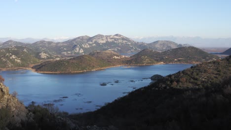 AERIAL---Lake-Skadar,-valley,-and-mountains,-Montenegro,-forward-shot