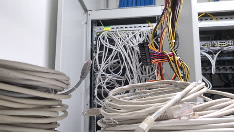 Closeup-push-out-of-many-electrical-and-network-wires-at-technical-hub