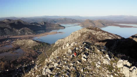 AERIAL---People-trekking-in-mountains-around-Lake-Skadar,-Montenegro,-forward