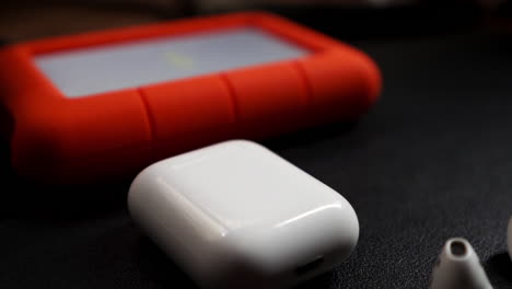 Rugged-lacie-hard-drive-backup-lined-up-next-to-airpods