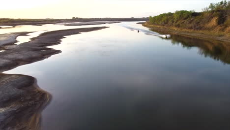 Drone-Shot-of-Jetskis-cruising-down-Saskatchewan-River,-SK,-Canada