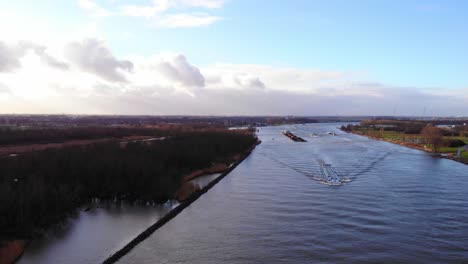 Aerial-Over-Oude-Maas-With-Liquid-Tankers-And-Barge-In-Distance-Travelling-Through-Zwijndrecht