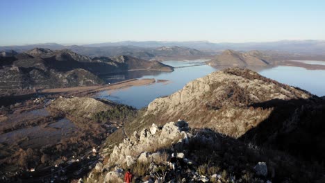 AERIAL---People-hiking-in-mountains-around-Lake-Skadar,-Montenegro,-forward