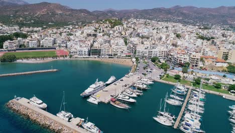 Drohnenaufnahme-über-Dem-Jachthafen,-Der-Strandpromenade,-Den-Stränden,-Dem-Sommer-In-Agios-Nikolaos,-Kreta,-Griechenland