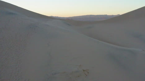 Reveal-of-a-desert-at-sunset-with-many-light-and-shadow-hills