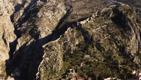 AERIAL---The-ancient-city-walls-of-Kotor,-Montenegro,-UNESCO-World-Heritage-Site