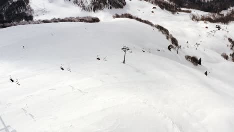 AERIAL---Ski-lift-in-the-mountains-at-Kolasin-ski-resort,-Montenegro,-pan-right