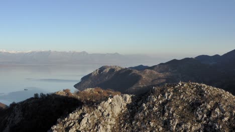 AERIAL---Beautiful-sky-in-mountains-around-Lake-Skadar,-Montenegro,-circle-pan